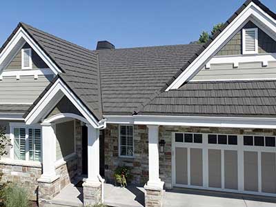 Front view of a typical mid-class home with gray Boral steel shingles on its roof