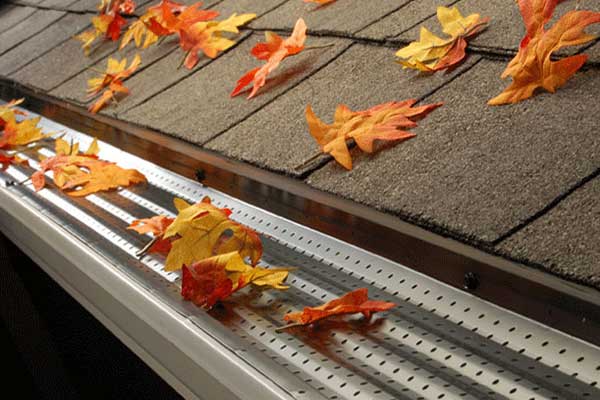 Close up of a steel Leaf Exterminator guard on a gutter system blocking leaves from falling in