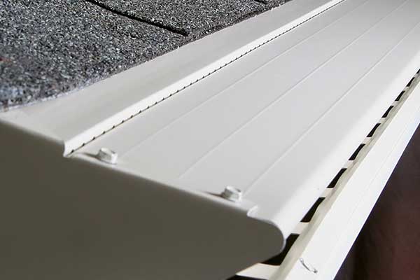 Close up of a white LeafX guard on a gutter system