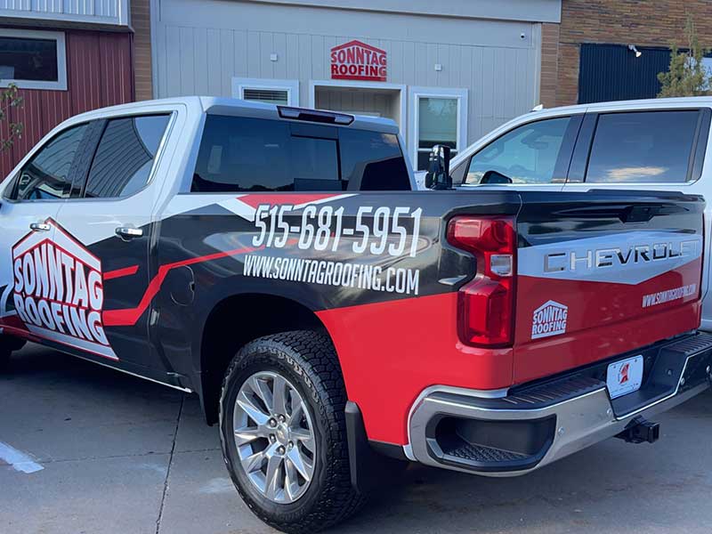 Close up of a Sonntag Roofing work pickup parked in front of the Sonntag Roofing office location