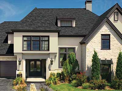 Front view of a typical mid-class home with black GAF shingles on its roof