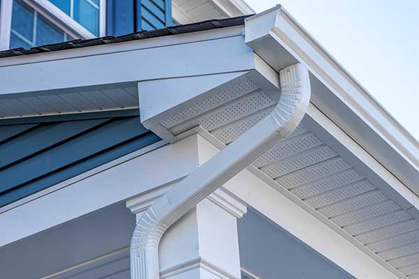 Close up of k-style white gutters on the fascia of a home
